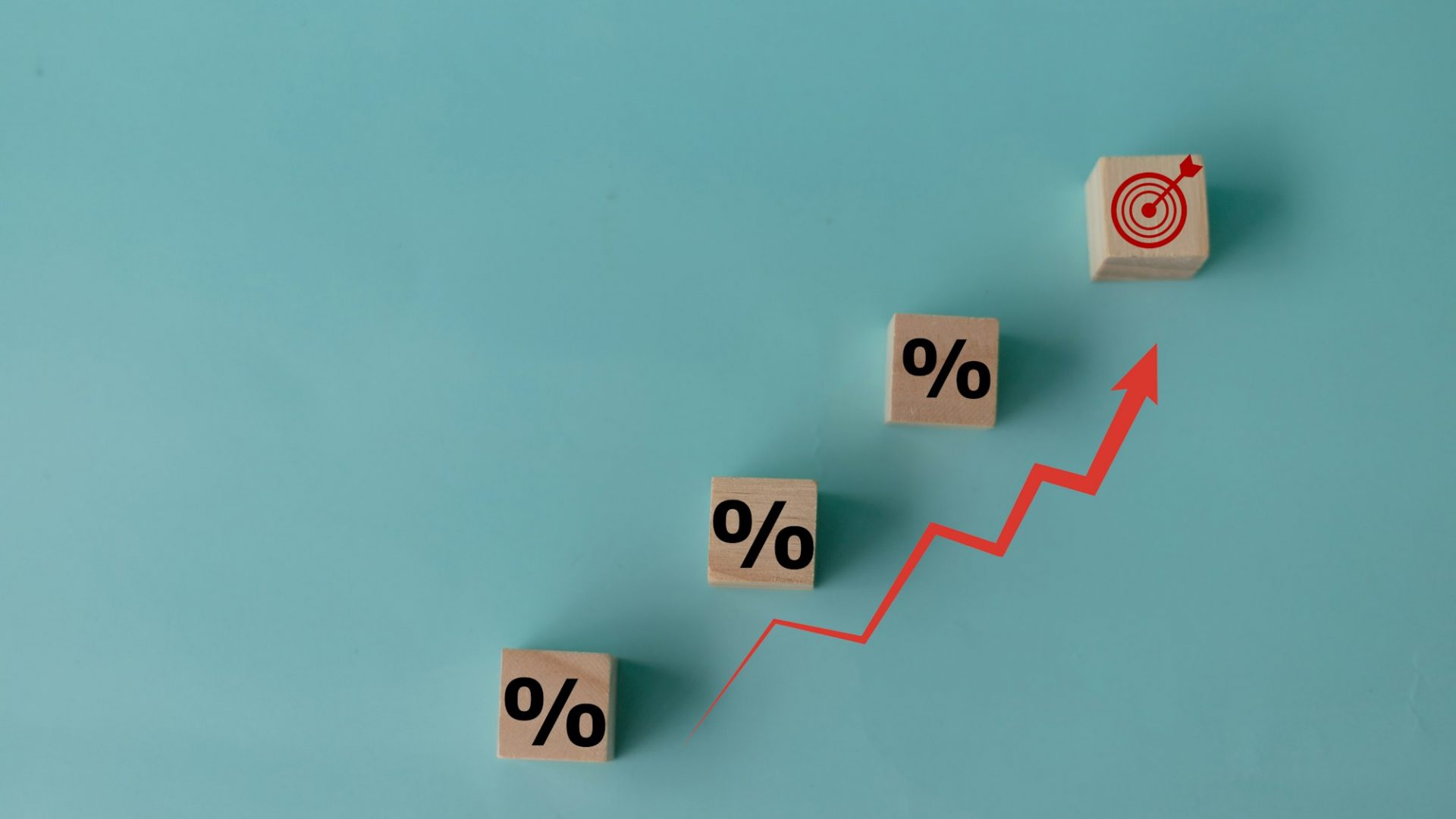 Concept of increasing sales. Wooden cubes with percentage icon and Rising arrow red