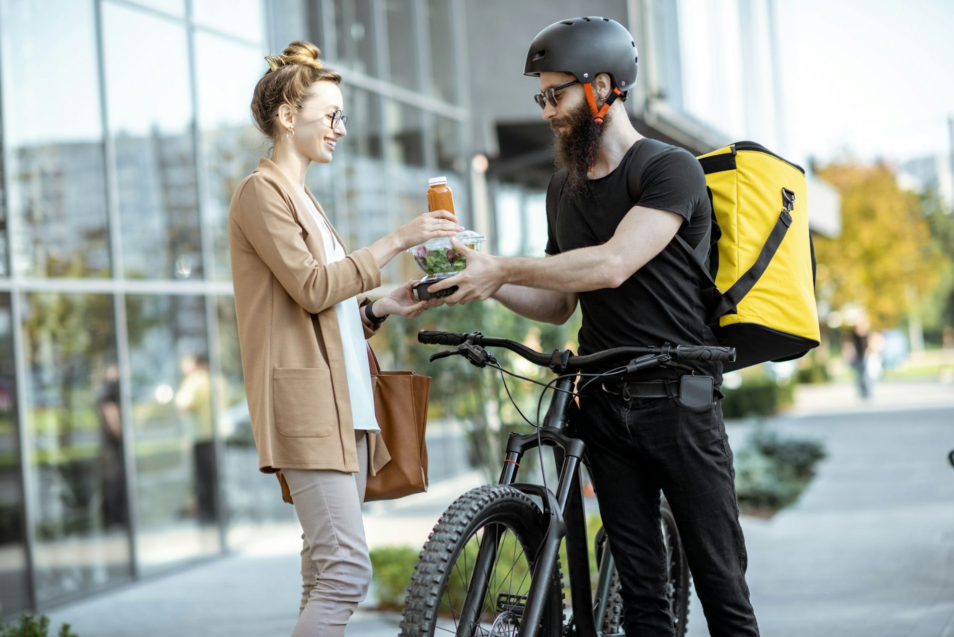 Courier delivering food to a business woman outdoors